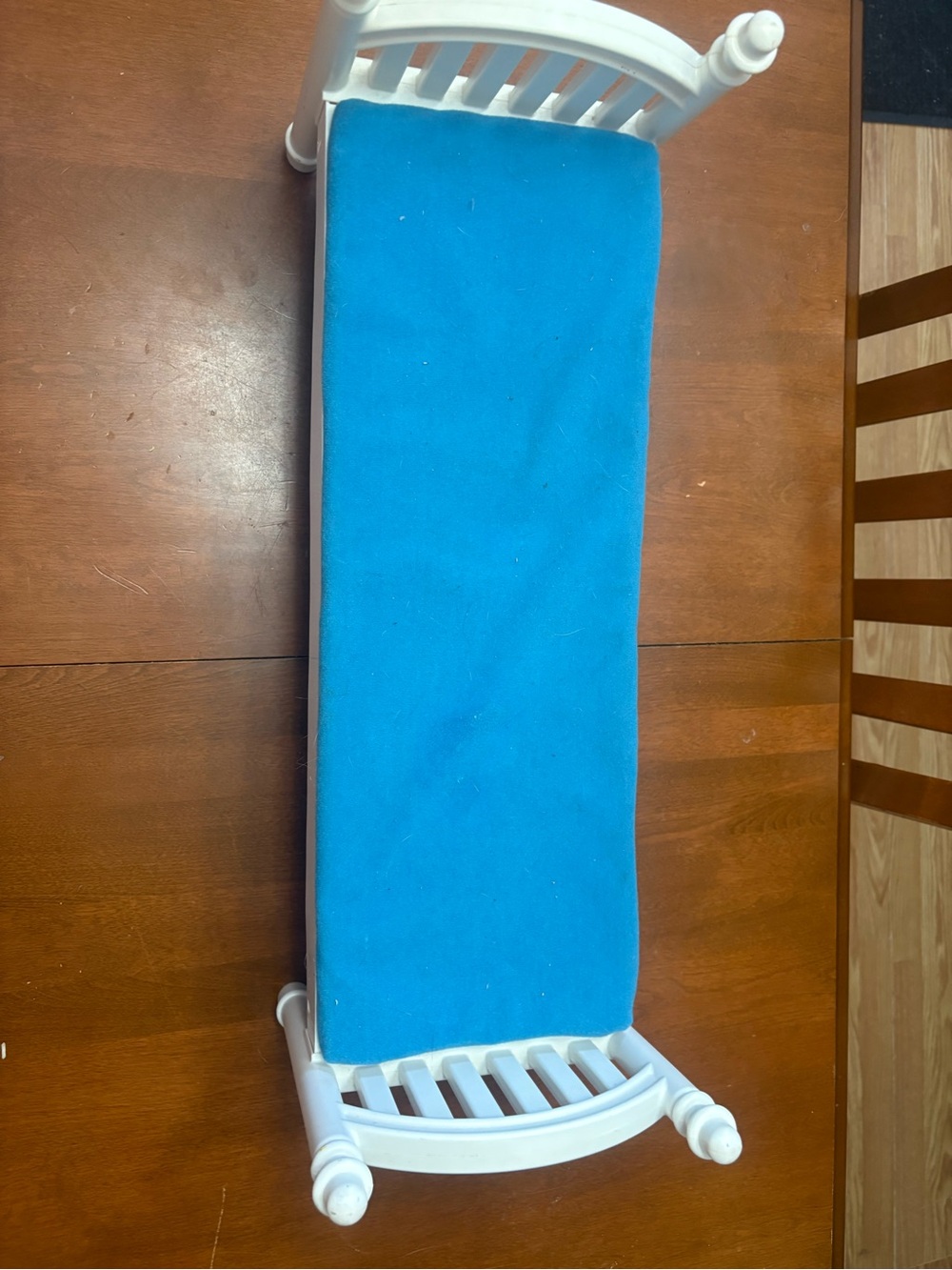 White Slatted Bench with Vibrant Blue Cushion